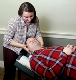 photo of a female doctor touching the neck of a male patient