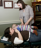 Doctor treating baby on mother's belly