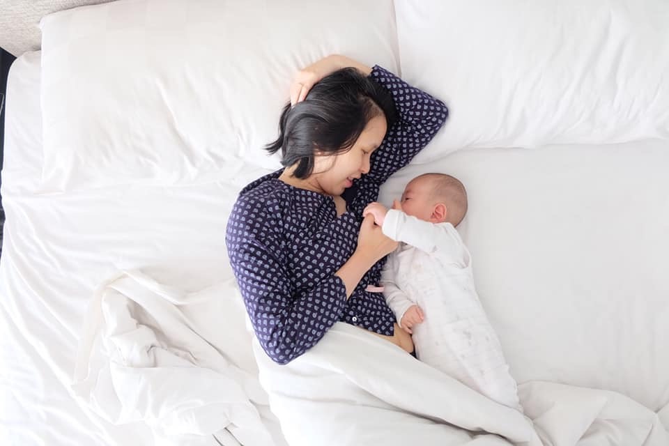 Baby and mother in bed